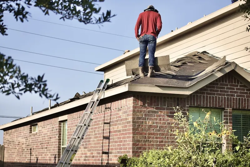 Professional roofer working on a residential roof in Lionville